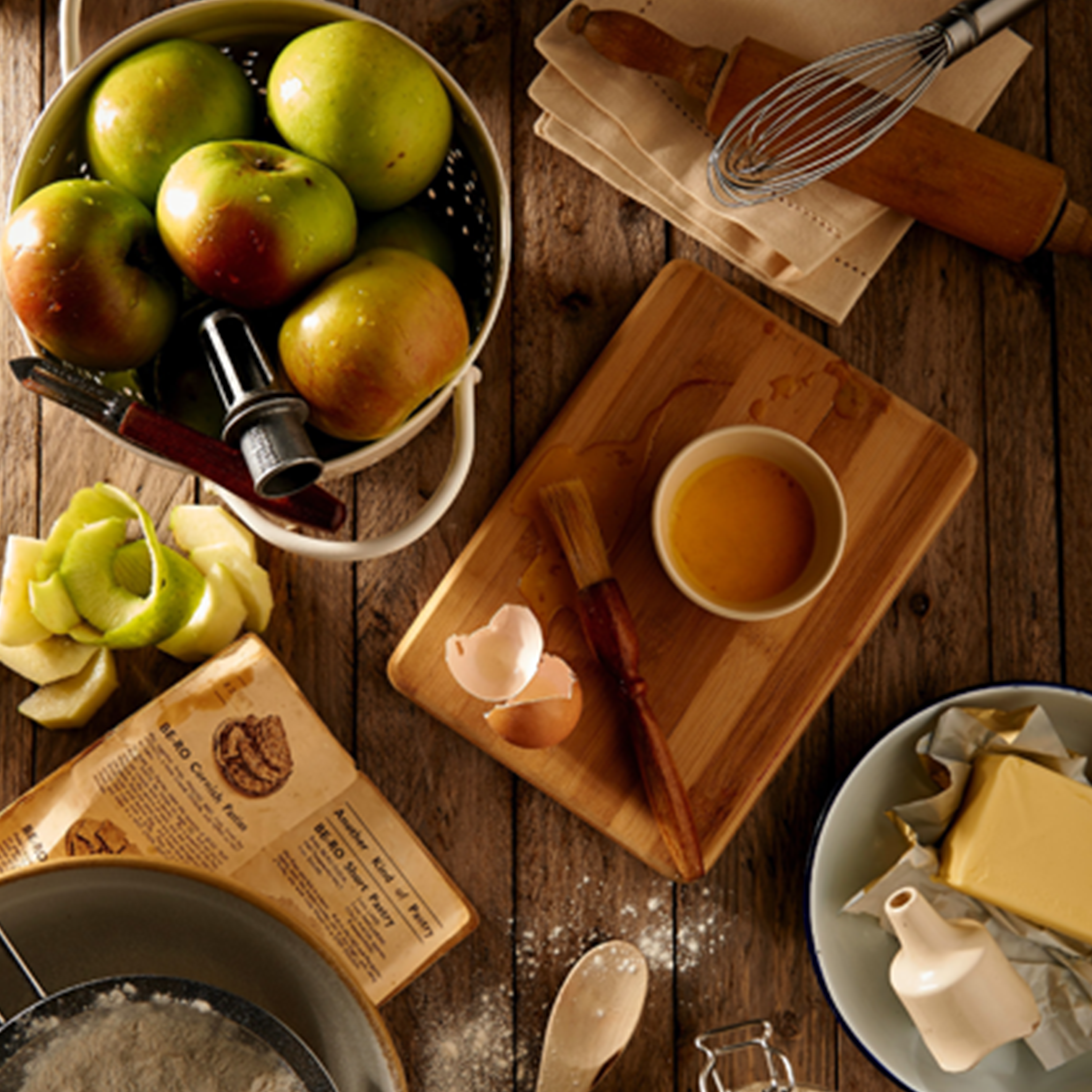 A messy table of someone in the process of making apple pie